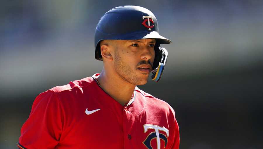 FILE - Minnesota Twins&apos; Carlos Correa reacts while batting during the first inning of a baseball game against the Chicago White Sox, Thursday, Sept. 29, 2022, in Minneapolis. Carlos Correa reversed course for a second time, agreeing Tuesday to a $200 million, six-year contract that keeps him with the Minnesota Twins after failing to complete agreements with the New York Mets and San Francisco Giants, a person familiar with the negotiations told The Associated Press on Tuesday, Jan. 10, 2023. (AP Photo/Abbie Parr, File)