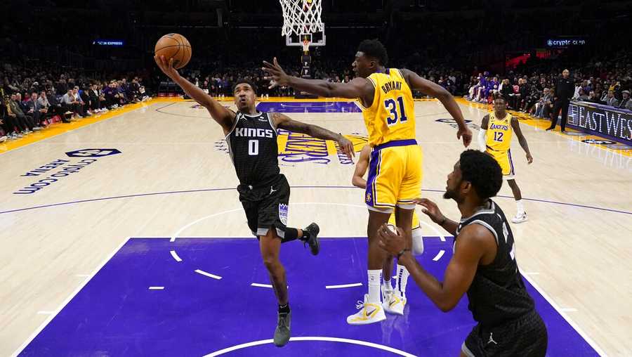 Sacramento Kings guard Malik Monk (0) shoots against Los Angeles Lakers center Thomas Bryant (31) during the first half of an NBA basketball game in Los Angeles, Wednesday, Jan. 18, 2023. (AP Photo/Ashley Landis)