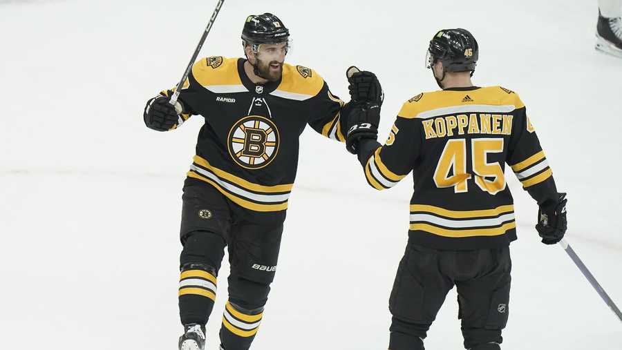 Boston Bruins left wing Nick Foligno, left, celebrates with left wing Joona Koppanen, right, after scoring in the second period of an NHL hockey game against the San Jose Sharks, Sunday, Jan. 22, 2023, in Boston. (AP Photo/Steven Senne)