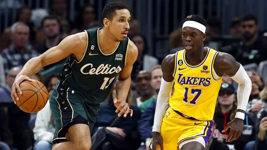 Boston Celtics&apos; Malcolm Brogdon (13) drives past Los Angeles Lakers&apos; Dennis Schroder (17) during the second half of an NBA basketball game, Saturday, Jan. 28, 2023, in Boston. (AP Photo/Michael Dwyer)