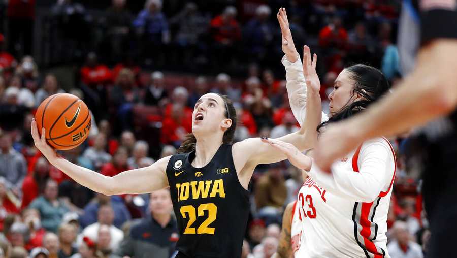 Iowa guard Caitlin Clark, left, goes in for a basket as Ohio State forward Rebeka Mikulasikova defends during the first half of an NCAA college basketball game at Value City Arena in Columbus, Ohio, Monday, Jan. 23, 2023. (AP Photo/Joe Maiorana)