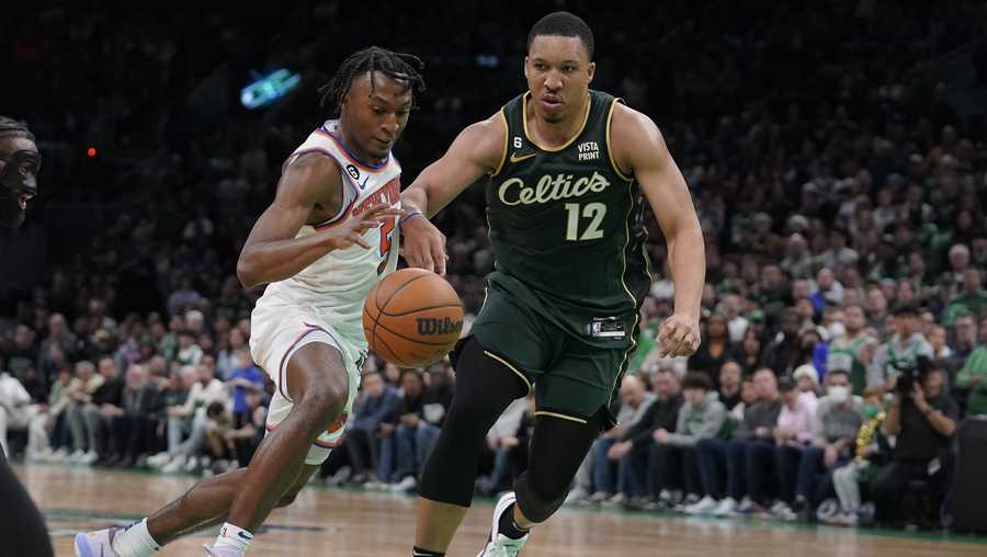 New York Knicks guard Immanuel Quickley drives toward the basket as Boston Celtics forward Grant Williams (12) defends in double overtime of an NBA basketball game, Sunday, March 5, 2023, in Boston. (AP Photo/Steven Senne)