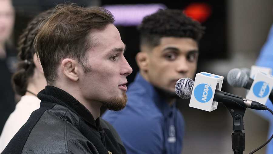 Iowa wrestler Spencer Lee, left, answers a question during a news conference on practice day at the NCAA Division I Wrestling National Championships, Wednesday, March 15, 2023, in Tulsa, Okla. Penn State's Roman Bravo-Young is at right.
