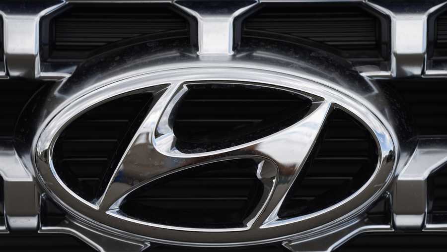 FILE - The Hyundai company logo is displayed Sunday, Sept. 12, 2021, in Littleton, Colo. Hyundai and Kia are telling owners, Friday, March 23, 2023 of over 571,000 SUVs and minivans in the U.S. to park them outdoors because the tow hitch harnesses can catch fire while they are parked or being driven. The Korean automakers are recalling the vehicles.