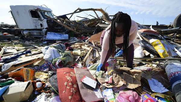 Kimberly Patton surveys through the belongings at the spot of a family member's home after a tornado destroyed the property two days earlier, Sunday, March 26, 2023, in Rolling Fork, Miss. Emergency officials in Mississippi say several people have been killed by tornadoes that tore through the state on Friday night, destroying buildings and knocking out power as severe weather produced hail the size of golf balls moved through several southern states. (AP Photo/Julio Cortez)