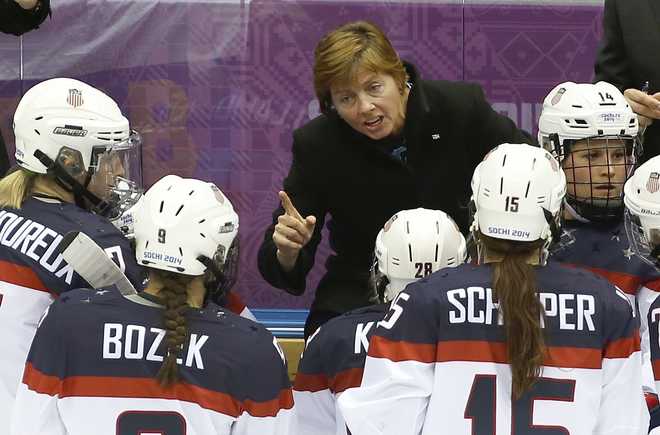 FILE - U.S. head coach Katie Stone talks to her team during a break in the second period of the women's ice hockey gold medal game against Canada during a hockey game at the 2014 Winter Olympics in Sochi, Russia, Thursday, Feb. 20, 2014. One of the most decorated coaches in women's hockey history has stepped down. 