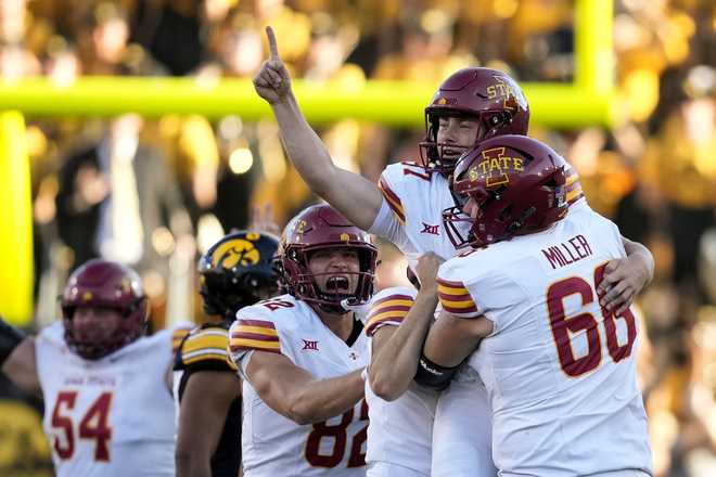 Iowa&#x20;State&#x20;place&#x20;kicker&#x20;Kyle&#x20;Konrardy&#x20;&#x28;97&#x29;&#x20;celebrates&#x20;with&#x20;teammate&#x20;Tyler&#x20;Miller&#x20;&#x28;66&#x29;&#x20;after&#x20;kicking&#x20;a&#x20;54-yard&#x20;field&#x20;goal&#x20;during&#x20;the&#x20;second&#x20;half&#x20;of&#x20;an&#x20;NCAA&#x20;college&#x20;football&#x20;game&#x20;against&#x20;Iowa,&#x20;Saturday,&#x20;Sept.&#x20;7,&#x20;2024,&#x20;in&#x20;Iowa&#x20;City,&#x20;Iowa.&#x20;Iowa&#x20;State&#x20;won&#x20;20-19.&#x20;&#x28;AP&#x20;Photo&#x2F;Charlie&#x20;Neibergall&#x29;