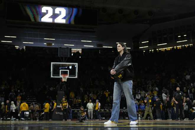 Former&#x20;Iowa&#x20;guard&#x20;and&#x20;current&#x20;Indiana&#x20;Fever&#x20;WNBA&#x20;player&#x20;Caitlin&#x20;Clark&#x20;stands&#x20;on&#x20;the&#x20;court&#x20;during&#x20;her&#x20;jersey&#x20;retirement&#x20;ceremony&#x20;after&#x20;an&#x20;NCAA&#x20;college&#x20;basketball&#x20;game&#x20;between&#x20;Iowa&#x20;and&#x20;Southern&#x20;California,&#x20;Sunday,&#x20;Feb.&#x20;2,&#x20;2025,&#x20;in&#x20;Iowa&#x20;City,&#x20;Iowa.&#x20;&#x28;AP&#x20;Photo&#x2F;Charlie&#x20;Neibergall&#x29;
