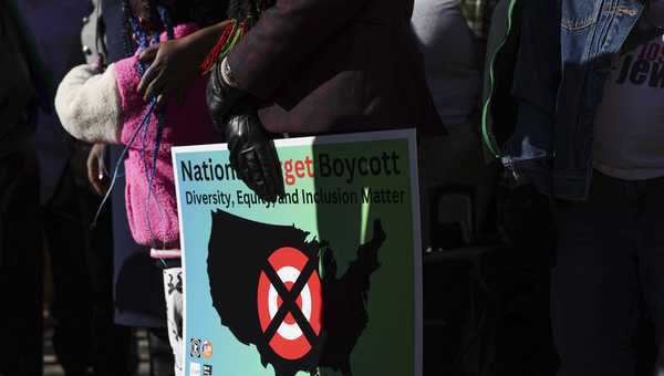 FILE - A community member holds a sign calling for a national boycott of Target stores during a news conference outside Target Corporation's headquarters Thursday, Jan. 30, 2025, in Minneapolis, Minnesota.