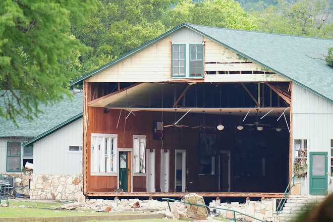 A wall is missing on a building at Camp Mystic along the banks of the Guadalupe River after a flash flood swept through the area Saturday, July 5, 2025, in Hunt, Texas. (AP Photo/Julio Cortez)