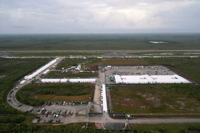 Work progresses on a new migrant detention facility dubbed Alligator Alcatraz at Dade-Collier Training and Transition facility in the Florida Everglades, on July 4, 2025, in Ochopee, Fla. (AP Photo/Rebecca Blackwell)