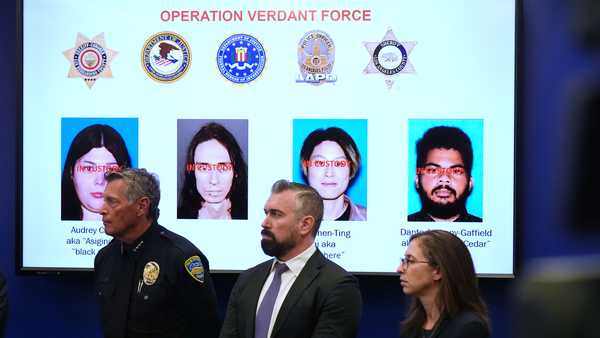 Photos of suspects of a terror plot are shown on a screen during a press conference Monday, Dec. 15, 2025, in Los Angeles. (AP Photo/Damian Dovarganes)