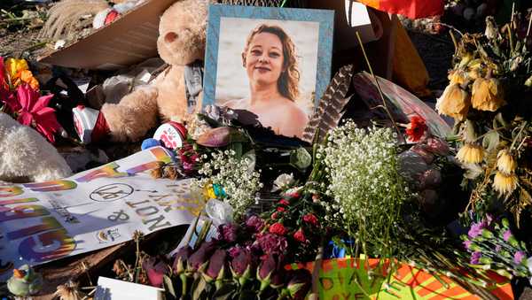 Flowers and photos are left at a memorial site for Renee Good on Saturday, Jan. 31, 2026, in Minneapolis. (AP Photo/Alex Brandon)