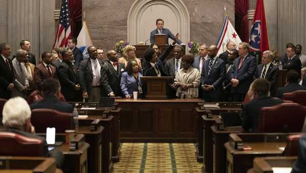 Former Rep. Justin Pearson, D-Memphis, waves to his supporters in the gallery as he delivers his final remarks on the floor of the House chamber as he is expelled from the legislature Thursday, April 6, 2023, in Nashville, Tenn. Tennessee Republicans ousted two of three House Democrats for using a bullhorn to shout support for pro-gun control protesters in the House chamber. (AP Photo/George Walker IV)