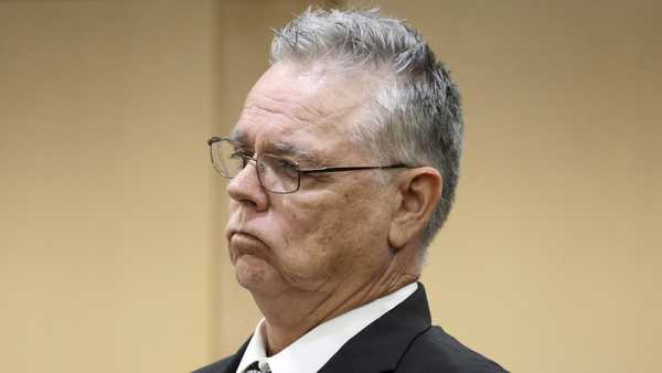 Former Marjory Stoneman Douglas High School School Resource Officer Scot Peterson stands during a hearing at the Broward County Courthouse in Fort Lauderdale, Fla., on Tuesday, May 30, 2023. Peterson is about to be tried on charges he failed to confront the gunman who murdered 14 students and three staff members at a Parkland high school five years ago. (Amy Beth Bennett/South Florida Sun-Sentinel via AP, Pool)