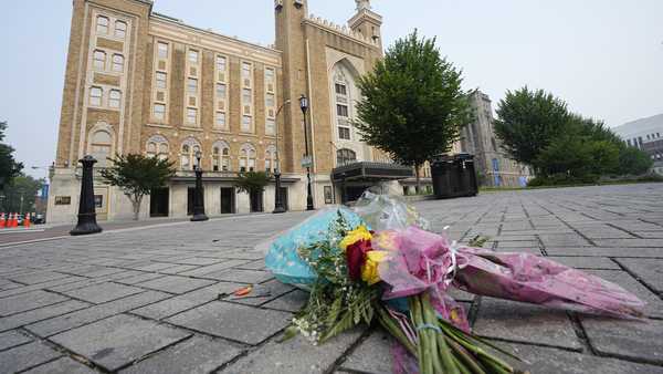 Flowers are placed in front of the Altria Theater which was the site of a mass shooting after a graduation ceremony Wednesday, June 7, 2023, in Richmond, Va. (AP Photo/Steve Helber)