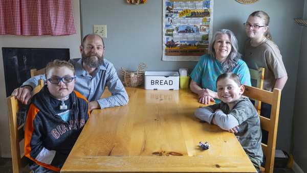 The Hill family, from left, Brady, Nathan, Cathrine, Monte, and Misha, pose for a photo at their home in Meridian, Idaho, June 19, 2023. Brady survived a rare brain cancer as a baby, but requires round the clock care. Each morning Nate and his wife spend about 3 hours with Brady performing his medical cares and getting him ready for the day. Families of severely disabled children across the country are worried about the future of crucial Medicaid payments they started receiving to provide care during the COVID-19 pandemic.  (AP Photo/Kyle Green)