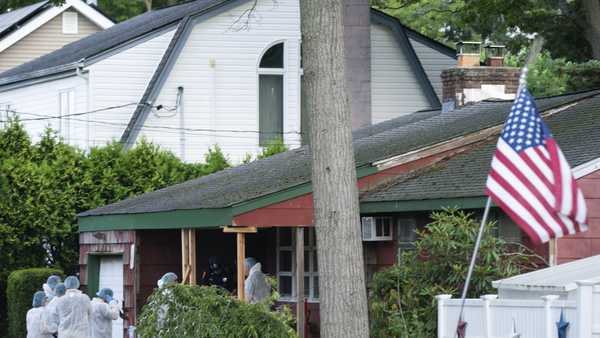 Crime laboratory officers arrive to the house where a suspect has been taken into custody on New York's Long Island in connection with a long-unsolved string of killings, Friday, July 14, 2023, in Massapequa, New York. (AP Photo/Eduardo Munoz Alvarez)