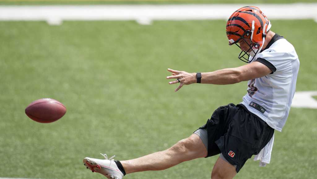 Cincinnati Bengals punter Drue Chrisman (4) warms up on the