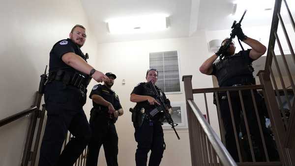 U.S. Capitol Police officers clear a stairwell in the Dirksen Senate Office Building next to the Russell Senate Office Building, Wednesday, Aug. 2, 2023, on Capitol Hill in Washington. (AP Photo/J. Scott Applewhite)