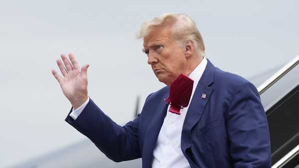 Former President Donald Trump waves as he steps off his plane at Ronald Reagan Washington National Airport, Thursday, Aug. 3, 2023, in Arlington, Va., as he heads to Washington to face a judge on federal conspiracy charges alleging Trump conspired to subvert the 2020 election. (AP Photo/Alex Brandon)