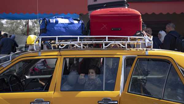 Palestinians wait to cross into Egypt at the Rafah border crossing in the Gaza Strip on Monday, Oct.16, 2023.