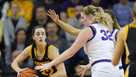 Iowa guard Caitlin Clark (22) passes around Northern Iowa center Rachael Heittola (32) during the first half of an NCAA college basketball game, Sunday, Nov. 12, 2023, in Cedar Falls, Iowa. (AP Photo/Charlie Neibergall)
