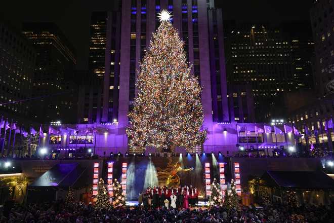 Iconic Christmas tree at Rockefeller Center illuminated in midst of pro ...