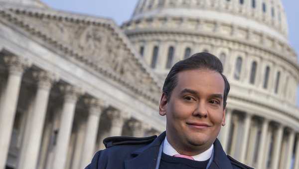 Rep. George Santos, R-N.Y., faces reporters at the Capitol in Washington, early Thursday, Nov. 30, 2023. After a scathing report by the House Ethics Committee citing egregious violations, Santos could be expelled from Congress this week. (AP Photo/J. Scott Applewhite)