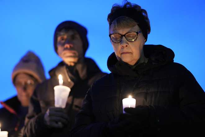 Local&#x20;&#x20;residents&#x20;pray&#x20;during&#x20;a&#x20;candlelight&#x20;vigil&#x20;following&#x20;a&#x20;shooting&#x20;at&#x20;Perry&#x20;High&#x20;School,&#x20;Thursday,&#x20;Jan.&#x20;4,&#x20;2024,&#x20;in&#x20;Perry,&#x20;Iowa.&#x20;&#x28;AP&#x20;Photo&#x2F;Charlie&#x20;Neibergall&#x29;