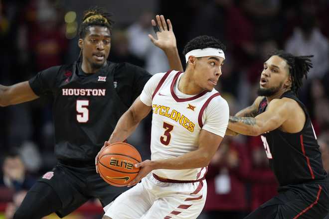 Iowa&#x20;State&#x20;guard&#x20;Tamin&#x20;Lipsey&#x20;&#x28;3&#x29;&#x20;drives&#x20;between&#x20;Houston&#x20;forward&#x20;Ja&amp;apos&#x3B;Vier&#x20;Francis&#x20;&#x28;5&#x29;&#x20;and&#x20;guard&#x20;Emanuel&#x20;Sharp&#x20;&#x28;21&#x29;&#x20;during&#x20;the&#x20;first&#x20;half&#x20;of&#x20;an&#x20;NCAA&#x20;college&#x20;basketball&#x20;game&#x20;Tuesday,&#x20;Jan.&#x20;9,&#x20;2024,&#x20;in&#x20;Ames,&#x20;Iowa.&#x20;&#x28;AP&#x20;Photo&#x2F;Charlie&#x20;Neibergall&#x29;