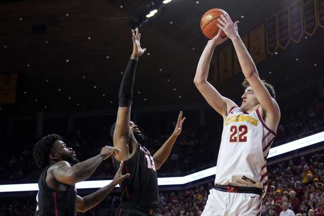 Iowa&#x20;State&#x20;forward&#x20;Milan&#x20;Momcilovic&#x20;&#x28;22&#x29;&#x20;shoots&#x20;over&#x20;Houston&#x20;guard&#x20;Jamal&#x20;Shead,&#x20;left,&#x20;and&#x20;forward&#x20;J&amp;apos&#x3B;Wan&#x20;Roberts&#x20;&#x28;13&#x29;&#x20;during&#x20;the&#x20;second&#x20;half&#x20;of&#x20;an&#x20;NCAA&#x20;college&#x20;basketball&#x20;game,&#x20;Tuesday,&#x20;Jan.&#x20;9,&#x20;2024,&#x20;in&#x20;Ames,&#x20;Iowa.&#x20;Iowa&#x20;State&#x20;won&#x20;57-53.&#x20;&#x28;AP&#x20;Photo&#x2F;Charlie&#x20;Neibergall&#x29;