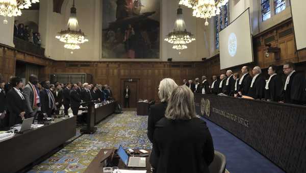 Judges and parties stand up during a hearing at the International Court of Justice in The Hague, Netherlands, Friday, Jan. 12, 2024. The United Nations' top court opened hearings Thursday into South Africa's allegation that Israel's war with Hamas amounts to genocide against Palestinians, a claim that Israel strongly denies. (AP Photo/Patrick Post)