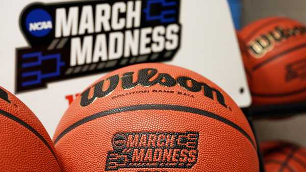 FILE - In this March 16, 2020, file photo, official March Madness 2020 tournament basketballs are displayed in a storeroom at the CHI Health Center Arena, in Omaha, Neb. The dominos started tumbling in March, when the NCAA abruptly called off March Madness, given no choice but to forgo a nearly $800 million TV payment that helps keep the entire college sports machine running. (AP Photo/Nati Harnik, File)