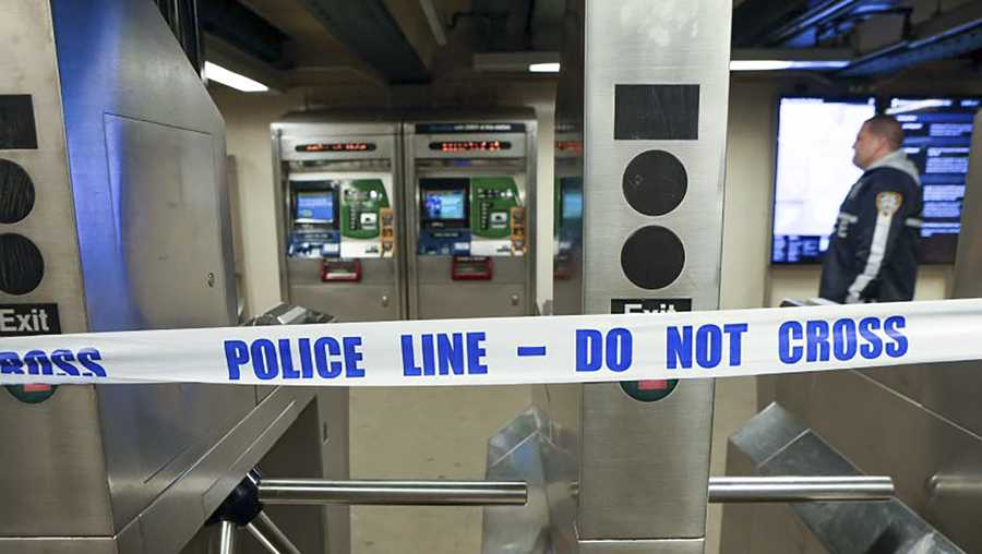 New York Police walk through the Mount Eden subway station while investigating a shooting, Monday, Feb. 12, 2024, in the Bronx borough of New York. Several people were shot Monday at the New York City subway station, police said. (New York Police Department via AP)