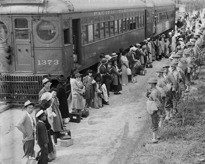 In&#x20;this&#x20;photo&#x20;provided&#x20;by&#x20;the&#x20;National&#x20;Archives,&#x20;Japanese&#x20;Americans&#x20;from&#x20;San&#x20;Pedro,&#x20;Calif.,&#x20;arrive&#x20;at&#x20;the&#x20;Santa&#x20;Anita&#x20;Assembly&#x20;Center&#x20;in&#x20;Arcadia,&#x20;Calif.,&#x20;on&#x20;April&#x20;5,&#x20;1942.&#x20;People&#x20;were&#x20;temporarily&#x20;housed&#x20;at&#x20;this&#x20;center&#x20;at&#x20;the&#x20;Santa&#x20;Anita&#x20;race&#x20;track&#x20;before&#x20;being&#x20;moved&#x20;inland&#x20;to&#x20;internment&#x20;camps&#x20;during&#x20;World&#x20;War&#x20;II.&#x20;&#x28;Clem&#x20;Albers&#x2F;War&#x20;Relocation&#x20;Authority&#x2F;National&#x20;Archives&#x20;via&#x20;AP&#x29;
