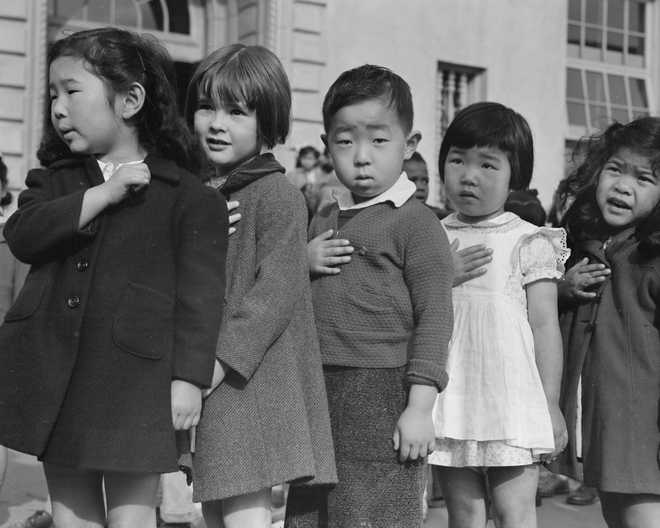 In&#x20;this&#x20;photo&#x20;provided&#x20;by&#x20;the&#x20;National&#x20;Archives,&#x20;first&#x20;grade&#x20;students&#x20;pledge&#x20;allegiance&#x20;to&#x20;the&#x20;flag&#x20;at&#x20;Raphael&#x20;Weill&#x20;Public&#x20;School&#x20;at&#x20;Geary&#x20;and&#x20;Buchanan&#x20;Streets&#x20;in&#x20;San&#x20;Francisco&#x20;on&#x20;April&#x20;20,&#x20;1942.&#x20;Many&#x20;children&#x20;of&#x20;Japanese&#x20;ancestry&#x20;attended&#x20;the&#x20;school,&#x20;but&#x20;were&#x20;relocated&#x20;to&#x20;an&#x20;internment&#x20;camp&#x20;for&#x20;Japanese&#x20;Americans.&#x20;&#x28;Dorothea&#x20;Lange&#x2F;War&#x20;Relocation&#x20;Authority&#x2F;National&#x20;Archives&#x20;via&#x20;AP&#x29;