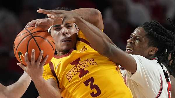 Iowa State's Tamin Lipsey (3) grabs a rebound in front of Houston's Joseph Tugler during the first half of an NCAA college basketball game Monday, Feb. 19, 2024, in Houston. (AP Photo/David J. Phillip)