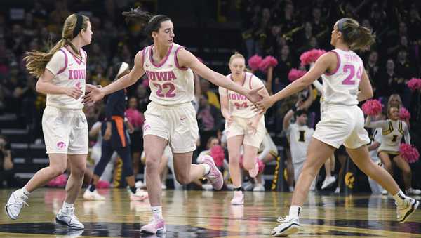 Iowa guard Caitlin Clark (22) celebrates a three point basket with Iowa guards Molly Davis, left, and Gabbie Marshall, right, during the first half of an NCAA college basketball game, Sunday, Feb. 25, 2024, in Iowa City, Iowa. (AP Photo/Cliff Jette)
