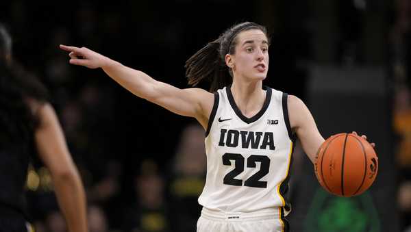Iowa guard Caitlin Clark (22) directs the team on offense during the second half of an NCAA college basketball game against Michigan, Thursday, Feb. 15, 2024, in Iowa City, Iowa. Iowa won 106-89. (AP Photo/Matthew Putney)