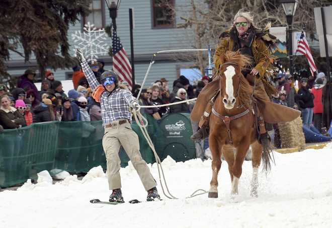 A&#x20;skijoring&#x20;team&#x20;competes&#x20;in&#x20;Leadville,&#x20;Colo.,&#x20;on&#x20;Saturday,&#x20;March&#x20;2,&#x20;2024.&#x20;Skijoring&#x20;draws&#x20;its&#x20;name&#x20;from&#x20;the&#x20;Norwegian&#x20;word&#x20;skikjoring,&#x20;meaning&#x20;&amp;quot&#x3B;ski&#x20;driving.&amp;quot&#x3B;&#x20;It&#x20;started&#x20;as&#x20;a&#x20;practical&#x20;mode&#x20;of&#x20;transportation&#x20;in&#x20;Scandinavia&#x20;and&#x20;became&#x20;popular&#x20;in&#x20;the&#x20;Alps&#x20;around&#x20;1900.&#x20;Today&amp;apos&#x3B;s&#x20;sport&#x20;features&#x20;horses&#x20;at&#x20;full&#x20;gallop&#x20;towing&#x20;skiers&#x20;by&#x20;rope&#x20;over&#x20;jumps&#x20;and&#x20;around&#x20;obstacles&#x20;as&#x20;they&#x20;try&#x20;to&#x20;lance&#x20;suspended&#x20;hoops&#x20;with&#x20;a&#x20;baton,&#x20;typically&#x20;a&#x20;ski&#x20;pole&#x20;that&amp;apos&#x3B;s&#x20;cut&#x20;in&#x20;half.&#x20;&#x28;AP&#x20;Photo&#x2F;Thomas&#x20;Peipert&#x29;