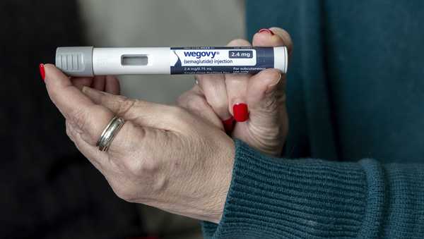 Donna Cooper holds up a dosage of Wegovy, a drug used for weight loss, at her home in Front Royal, Va., on Friday, March 1, 2024. 