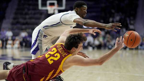 Iowa State forward Milan Momcilovic (22) and Kansas State guard Cam Carter chase a loose ball during the first half of an NCAA college basketball game Saturday, March 9, 2024, in Manhattan, Kan. (AP Photo/Charlie Riedel)