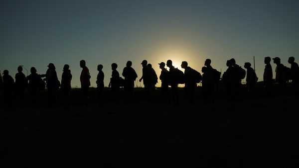 FILE - Migrants who crossed the Rio Grande and entered the U.S. from Mexico are lined up for processing by U.S. Customs and Border Protection, Sept. 23, 2023, in Eagle Pass, Texas. A divided Supreme Court on Tuesday, March 19, 2024, lifted a stay on a Texas law that gives police broad powers to arrest migrants suspected of crossing the border illegally, while a legal battle over immigration authority plays out. (AP Photo/Eric Gay, File)