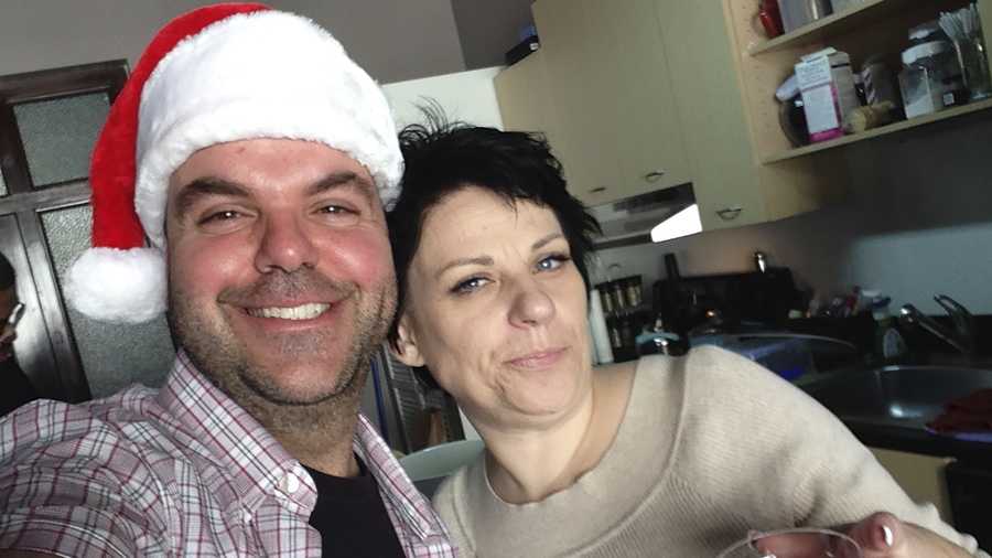 In this image provided by Johnathan Walton, Walton and Marianne Smyth  pose for a selfie in December 2013, at her tree trimming Christmas party in downtown Los Angeles. Smyth is in a Maine jail awaiting a hearing in April 2024 that will decide whether she can be extradited to the United Kingdom over a scam dating back more than 15 years in Northern Ireland. She is accused of stealing more than $170,000 from at least five victims from 2008 to 2010 in Northern Ireland, according to court records. (Johnathan Walton via AP)