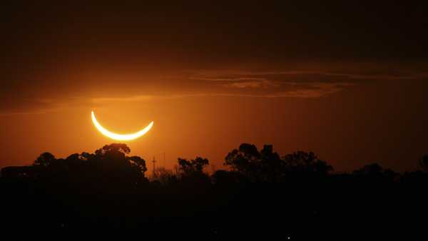 FILE - The moon passes in front of the setting sun during a total solar eclipse in Buenos Aires, Argentina, Tuesday, July 2, 2019.  Small towns and rural enclaves along the path of April's 2024 total solar eclipse are steeling for huge crowds of sun chasers who plan to catch a glimpse of day turning into dusk in North America. (AP Photo/Marcos Brindicci, File)