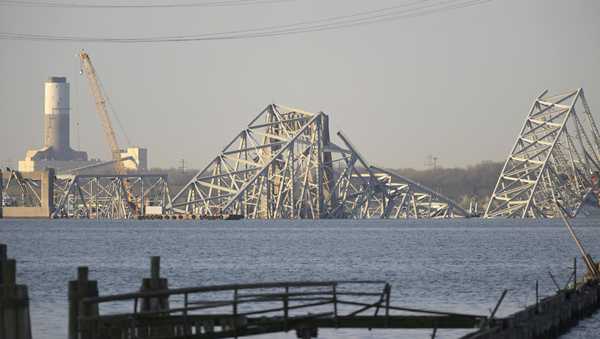 A crane is seen near the wreckage of the Francis Scott Key Bridge on Friday, March 29, 2024 in Baltimore. A cargo ship rammed into the major bridge in Baltimore early Tuesday, causing it to collapse in a matter of seconds. (AP Photo/Steve Ruark)