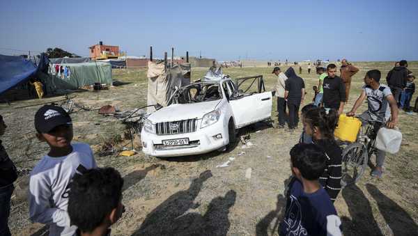 People inspect the site where World Central Kitchen workers were killed in Deir al-Balah, Gaza Strip, Tuesday, April 2, 2024. World Central Kitchen, an aid group, says an Israeli strike that hit its workers in Gaza killed at least seven people, including several foreigners. (AP Photo/Abdel Kareem Hana)
