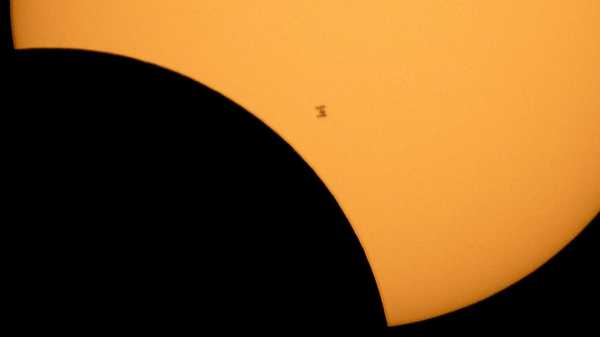 FILE - In this image made available by NASA, the International Space Station is silhouetted against the sun during a solar eclipse Monday, Aug. 21, 2017, as seen from Ross Lake, Northern Cascades National Park in Washington state.  Inmates in New York are suing the state corrections department over the decision to lock down prisons during the total solar eclipse, Monday, April 8, 2024. (Bill Ingalls/NASA via AP, File)