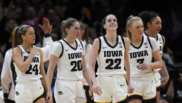 Iowa guard Caitlin Clark (22) reacts after making a three-point basket during the second half of a Final Four college basketball game against UConn in the women's NCAA Tournament, Friday, April 5, 2024, in Cleveland. (AP Photo/Carolyn Kaster)